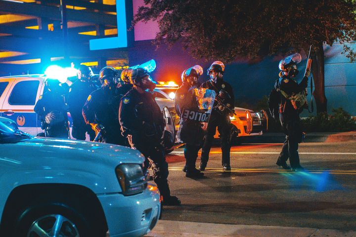 American riot police advancing in a group down a road